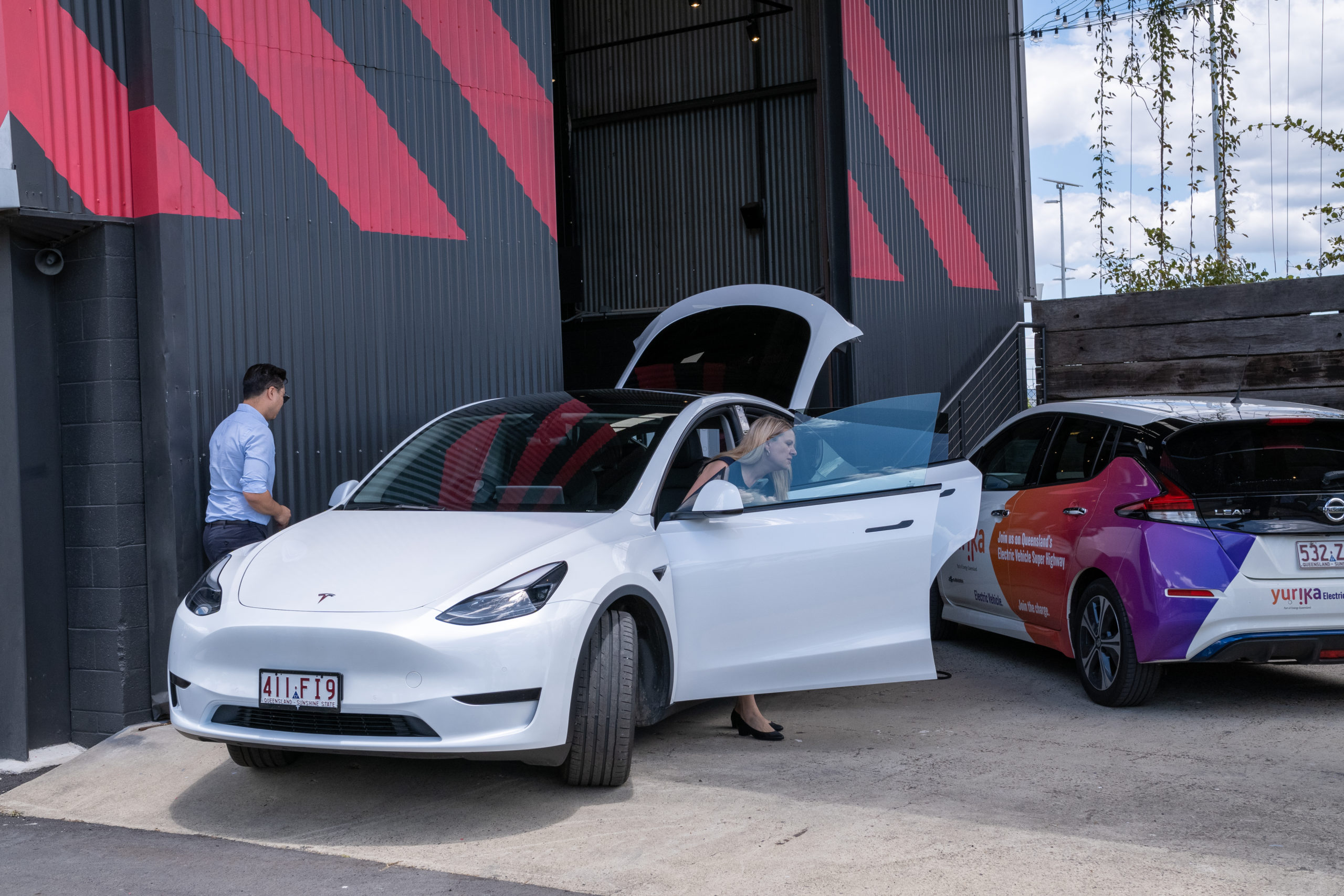 Electric Tesla car with branded Yurika electric vehicle Nissan Leaf